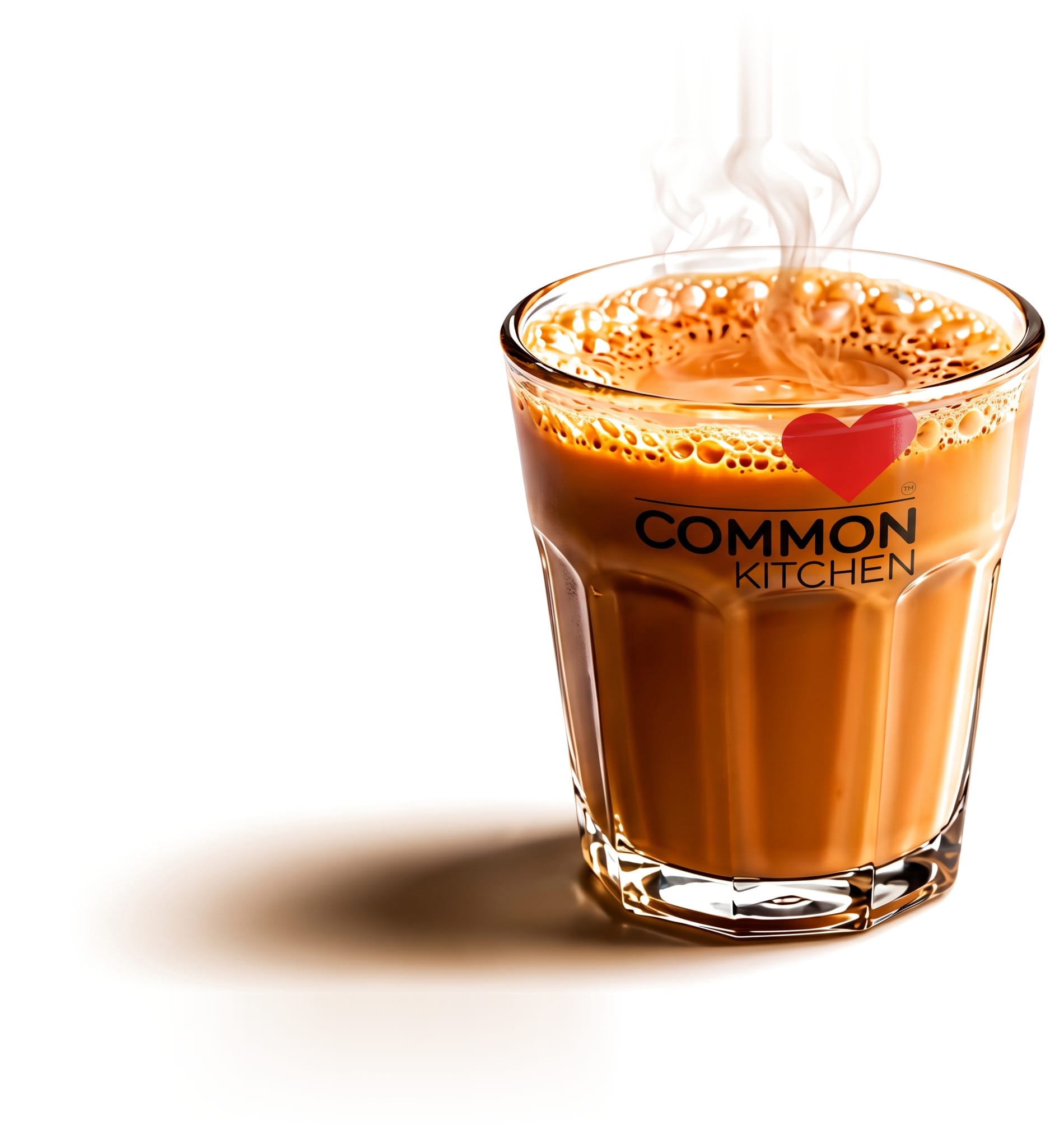 A steaming glass of chai printed with the Common Kitchen logo